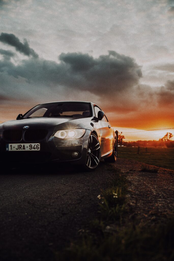 Stunning Black BMW Wallpaper: Front View with Glowing Headlights