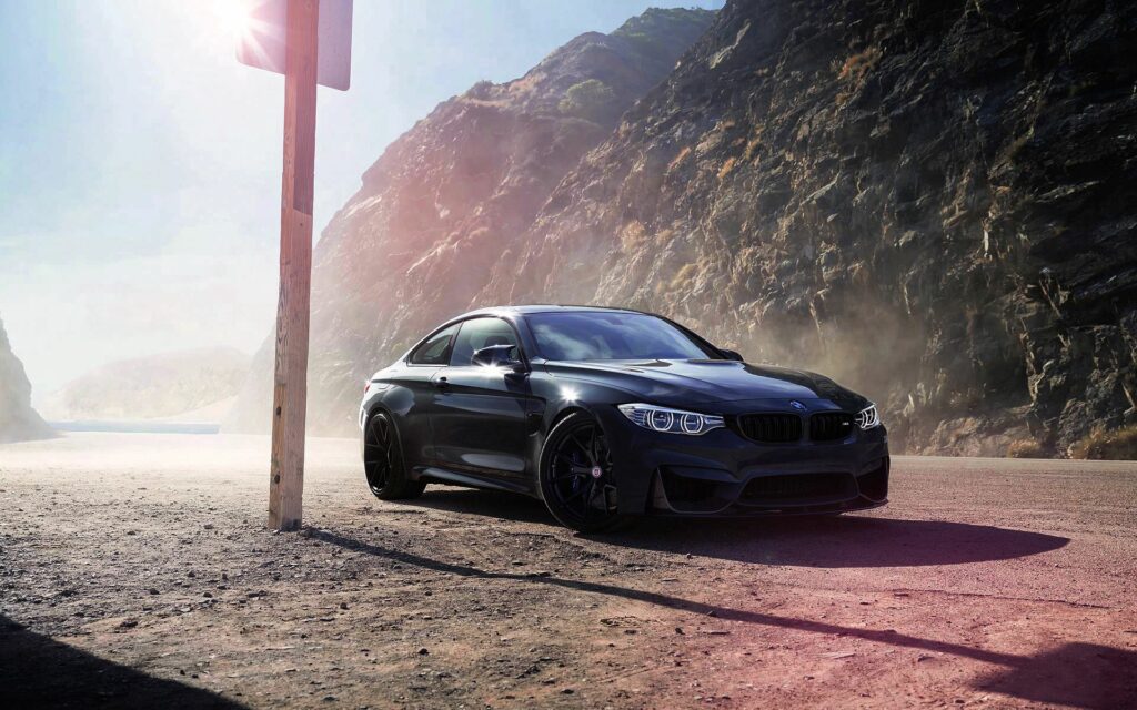 Sleek Black BMW M4 F82 in Dramatic Mountainous Wallpaper