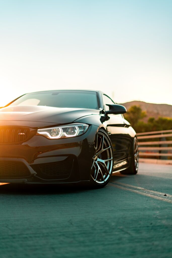 Front View of Sleek Black BMW M4 Wallpaper with Serene Background