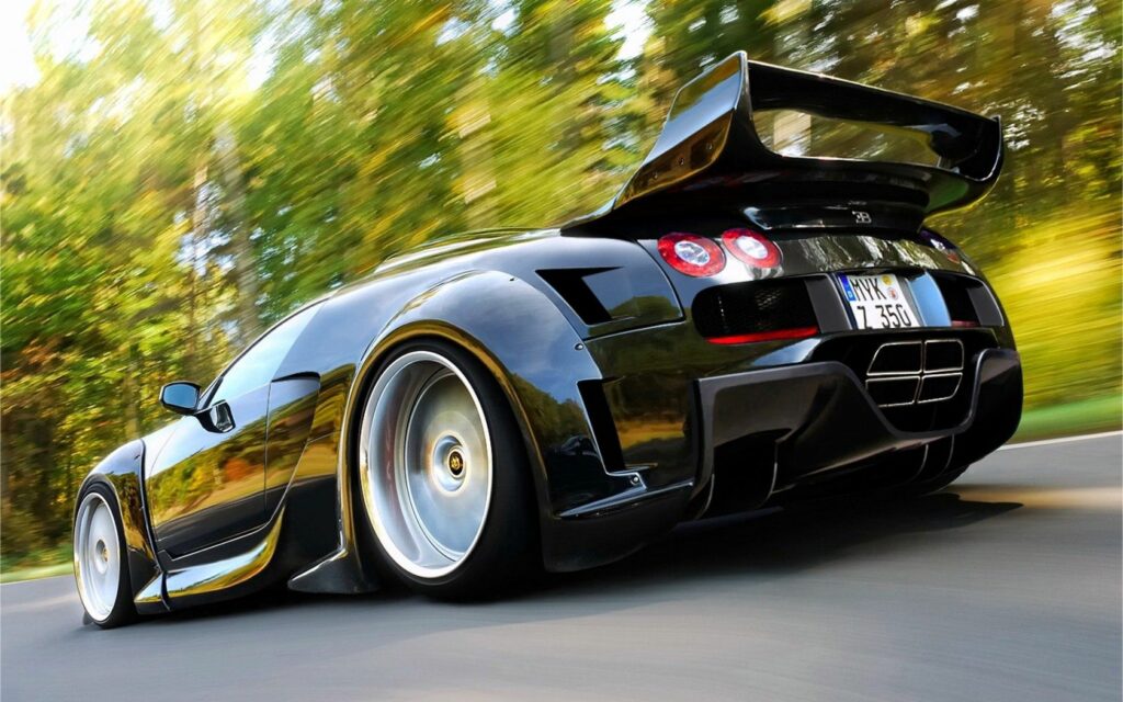 Sleek Black Bugatti in Motion: Ultimate Car Enthusiast Wallpaper