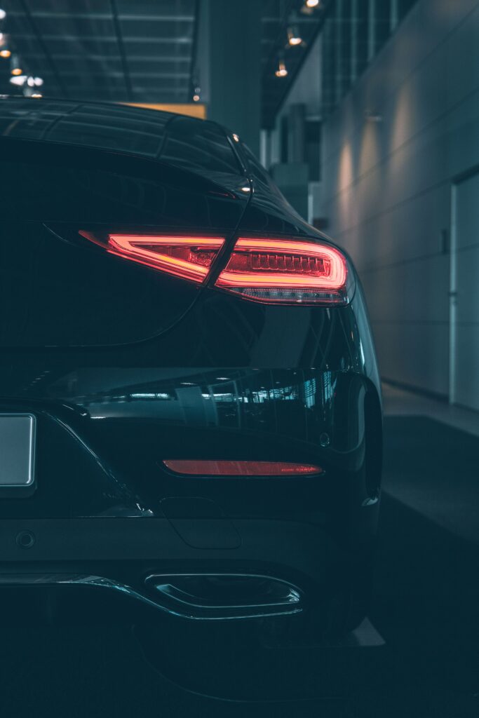 Sleek Black Car Wallpaper: Elegant Rear View with Stylish Tail Light
