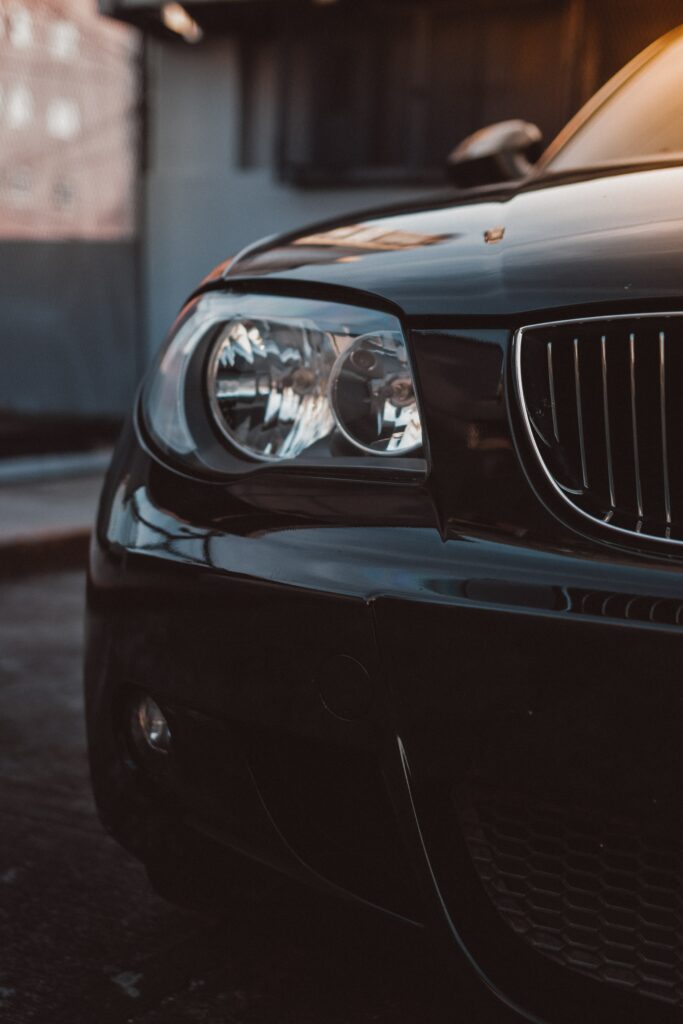 Sleek Black Car Front View Wallpaper with Stunning Headlight Details