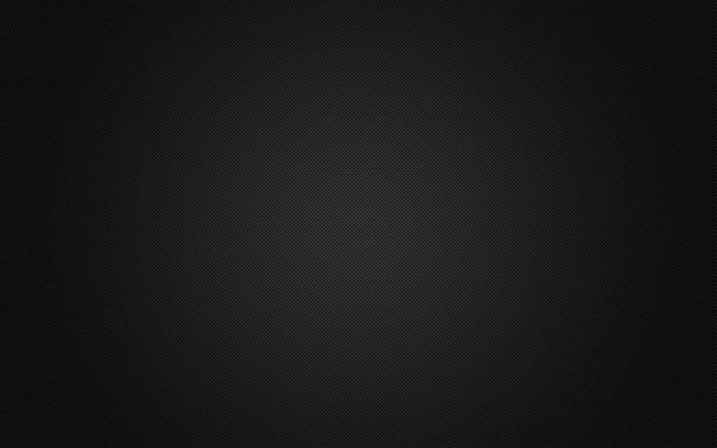 Black carbon fiber wallpaper with dark weave and subtle lighting for a modern desktop background