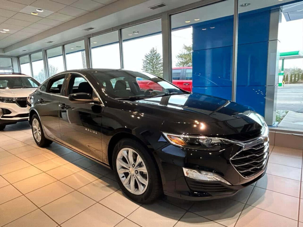 Stylish Black Chevrolet Sedan in Modern Showroom Wallpaper