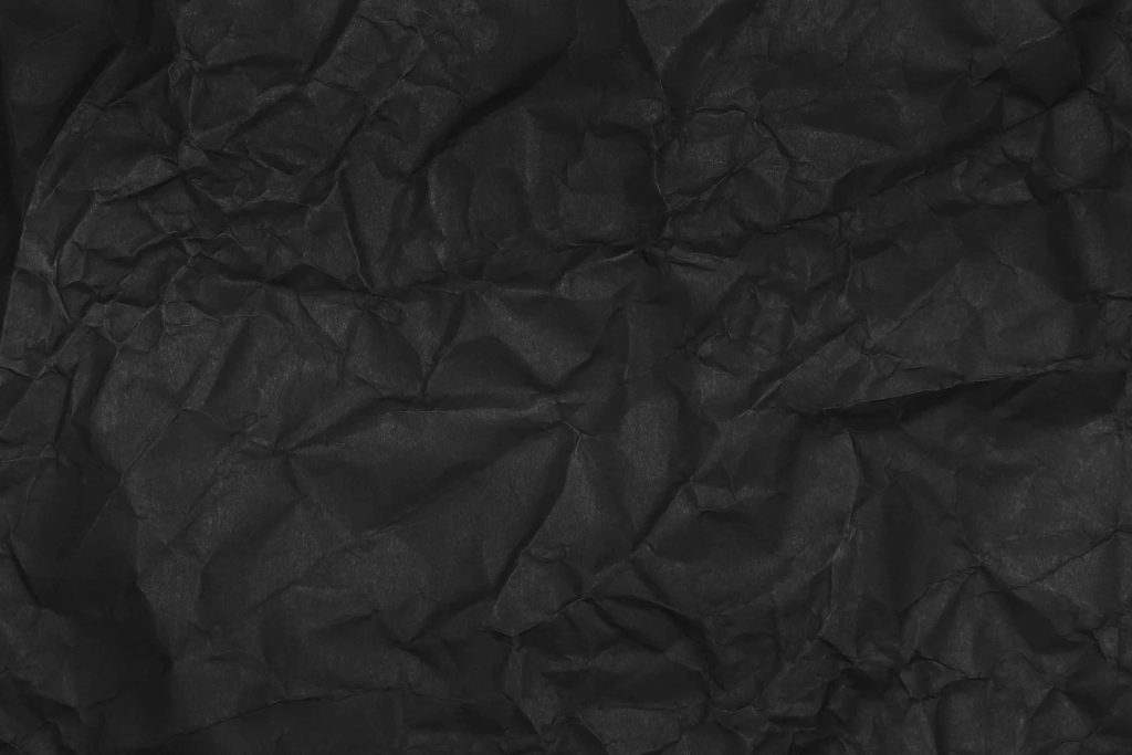 Black crumpled paper wallpaper textured dark matte folds minimalist moody background design