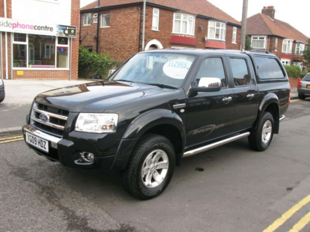 Sleek black Ford Ranger parked on quiet street Bold rugged design perfect automotive wallpaper