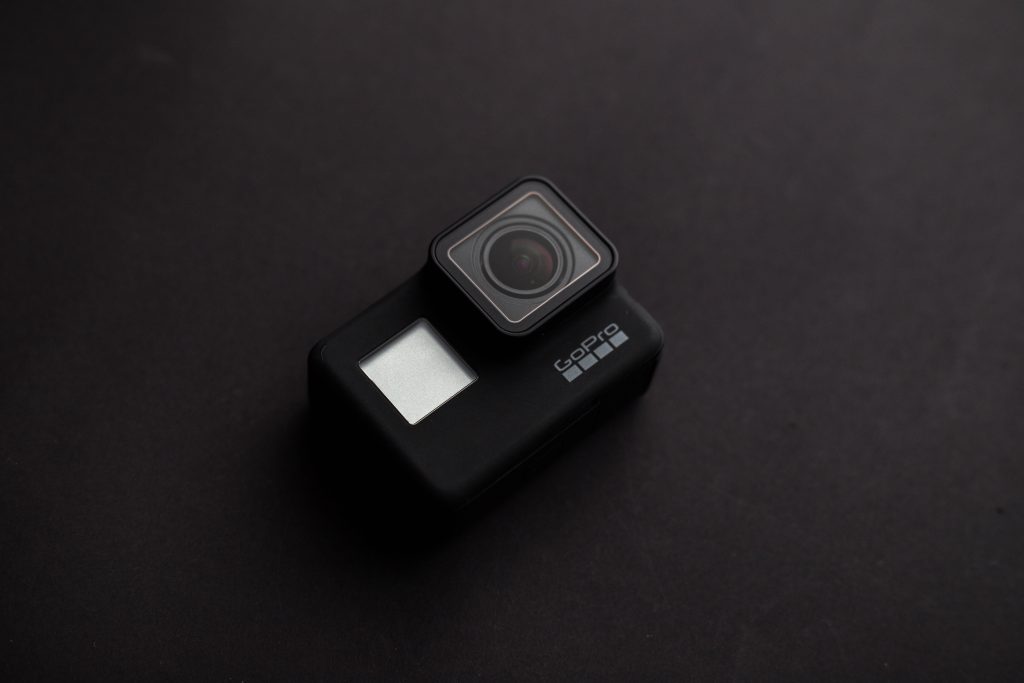Sleek black GoPro action camera on dark minimalist background with soft lighting detail Wallpaper