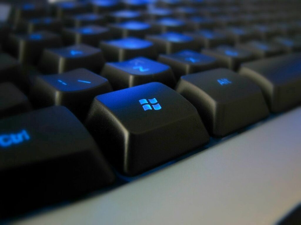 Stylish Black Keyboard with Glowing Blue Backlight Wallpaper