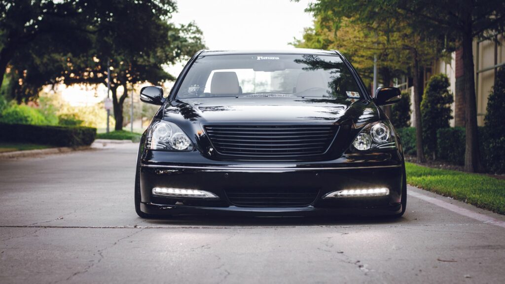 Sleek Black Lexus VIP Aesthetic on Serene Road with Greenery Background Wallpaper