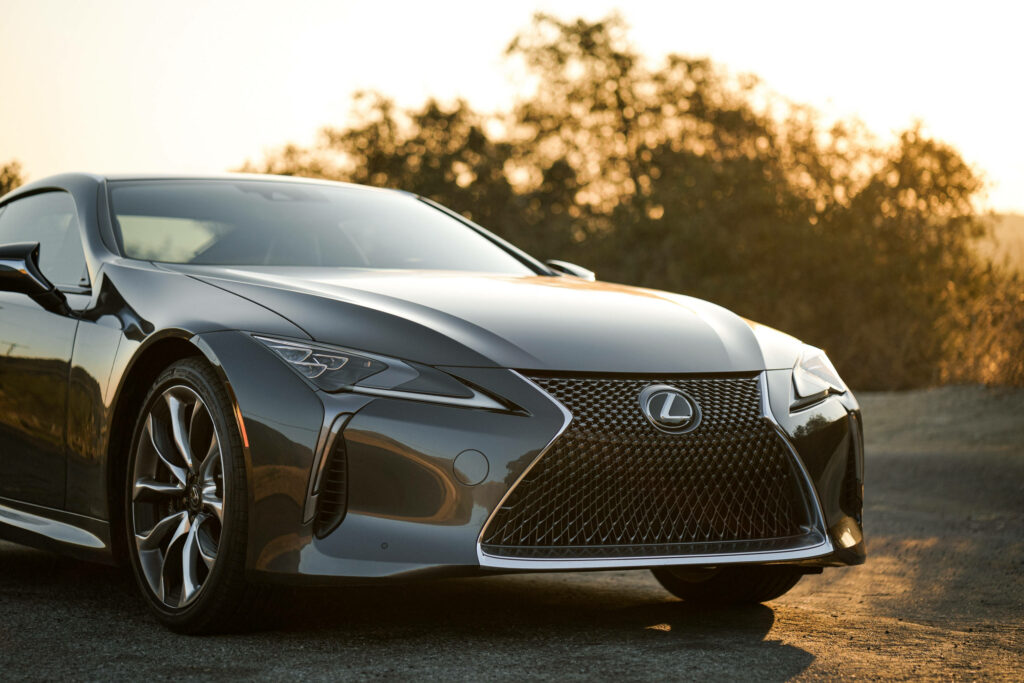 Sleek Black Lexus RX Wallpaper: Bold Design Against Sunset Background