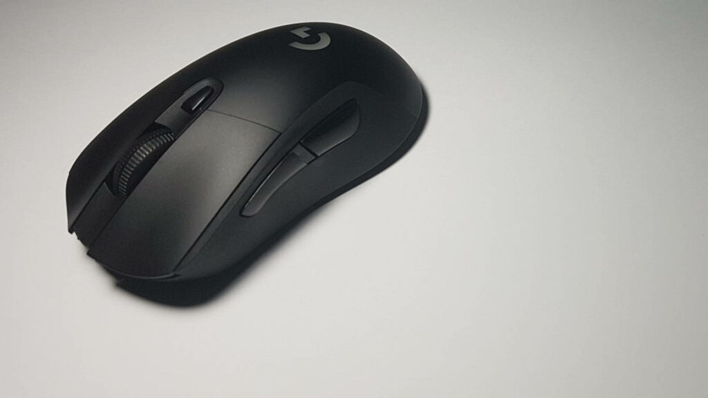 Sleek black Logitech ergonomic mouse on white surface showcasing modern design and comfort Wallpaper