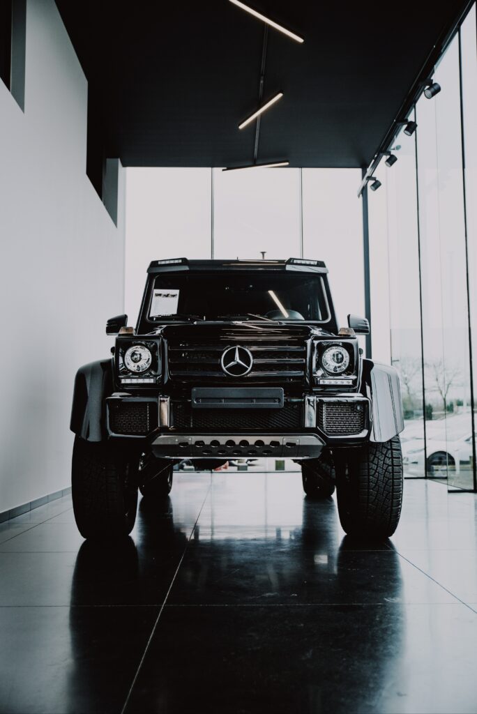 Luxury Black Mercedes SUV Front View Wallpaper in Modern Setting