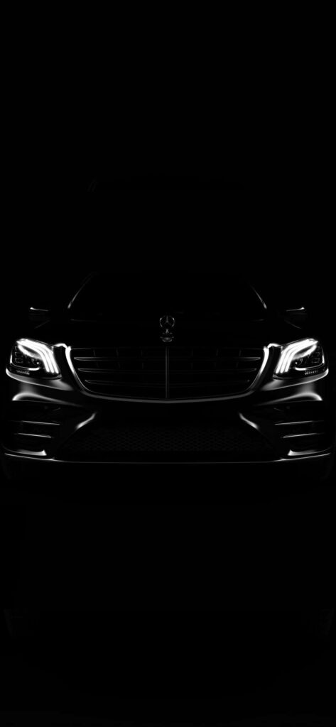 All black Mercedes car with iconic grille and sleek headlights on dark wallpaper background