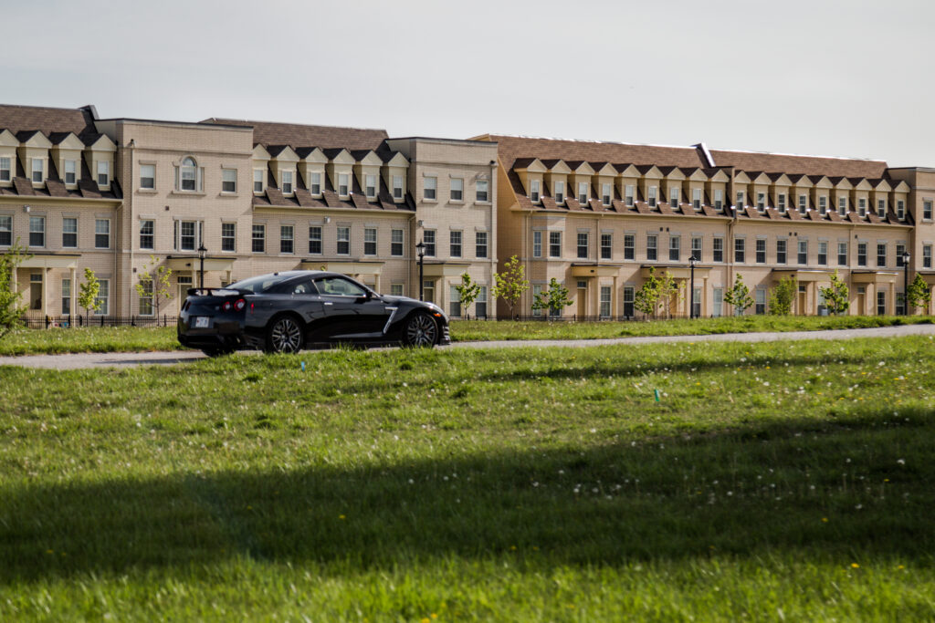 Sleek Black Nissan GT-R: Sporty Elegance in Suburban Setting Wallpaper