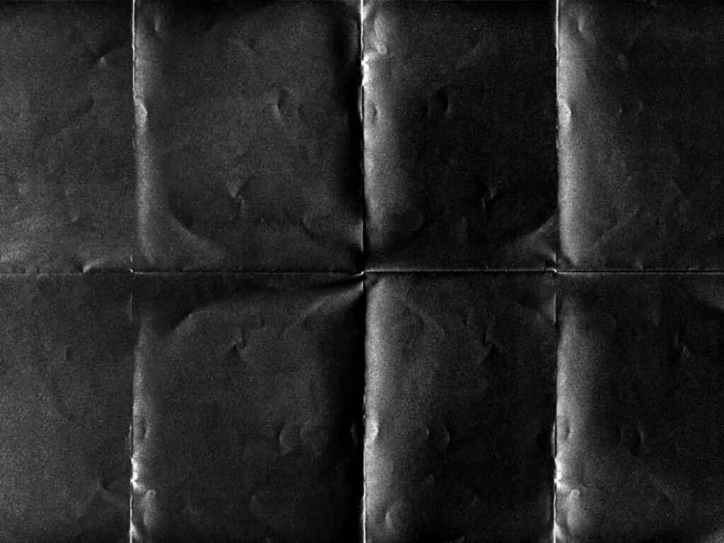 Sleek Black Paper Texture with Folded Design - Modern Wallpaper