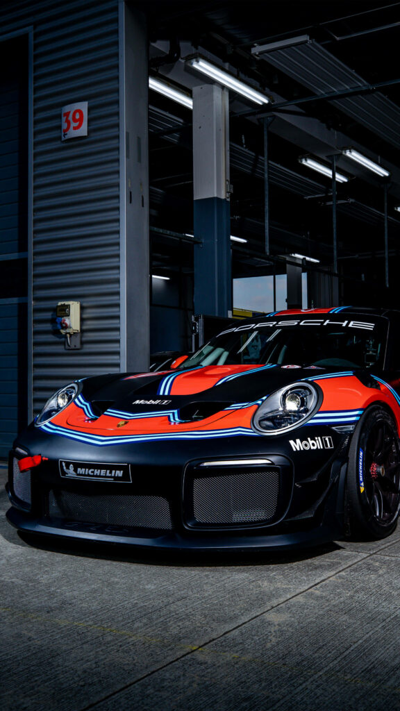 Dynamic Black & Red Porsche 911 Wallpaper in Racing Garage Setting