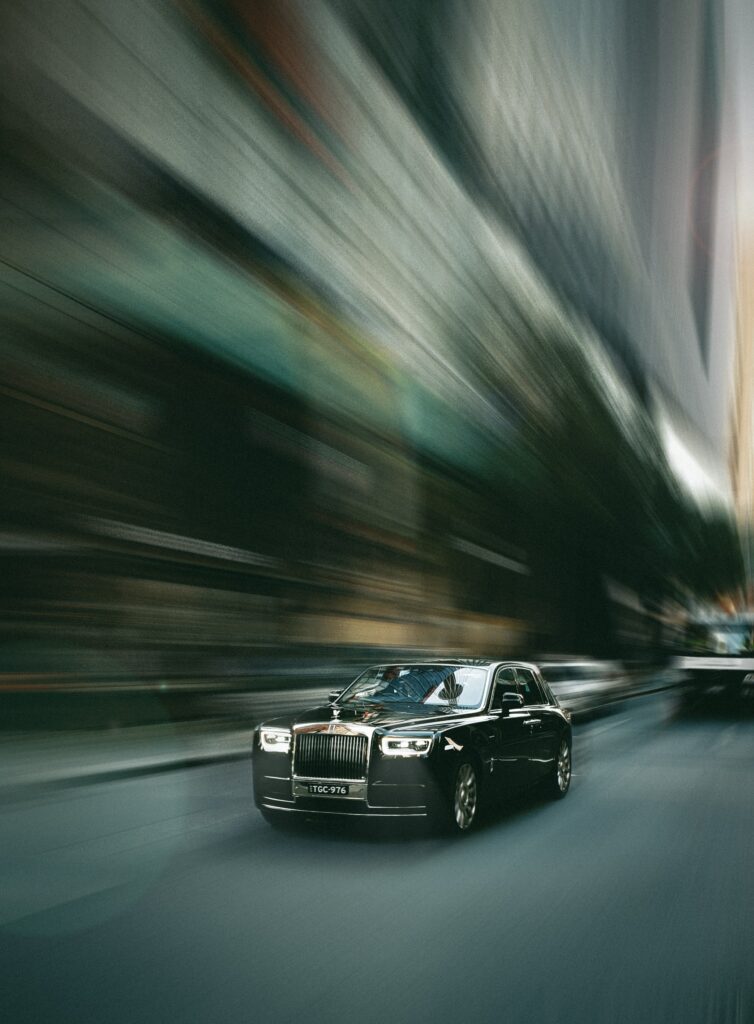 Luxurious Black Rolls-Royce in Motion: Stunning Wallpaper Background
