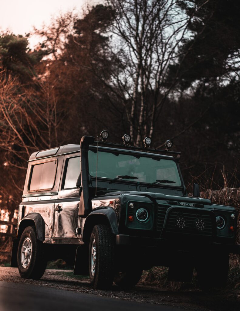 Stunning Black SUV Wallpaper: Bold Headlights & Natural Backdrop