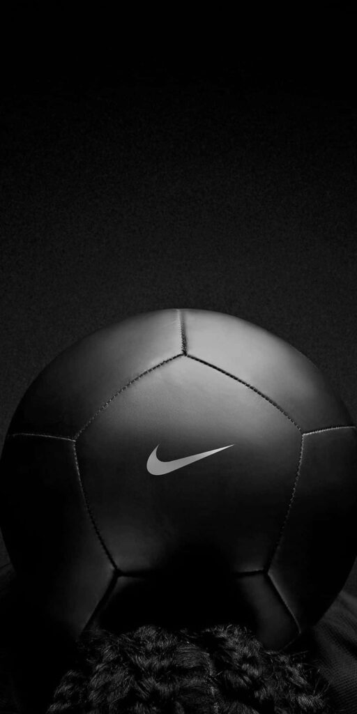 Sleek Black Soccer Ball Wallpaper: Modern Minimalist Design