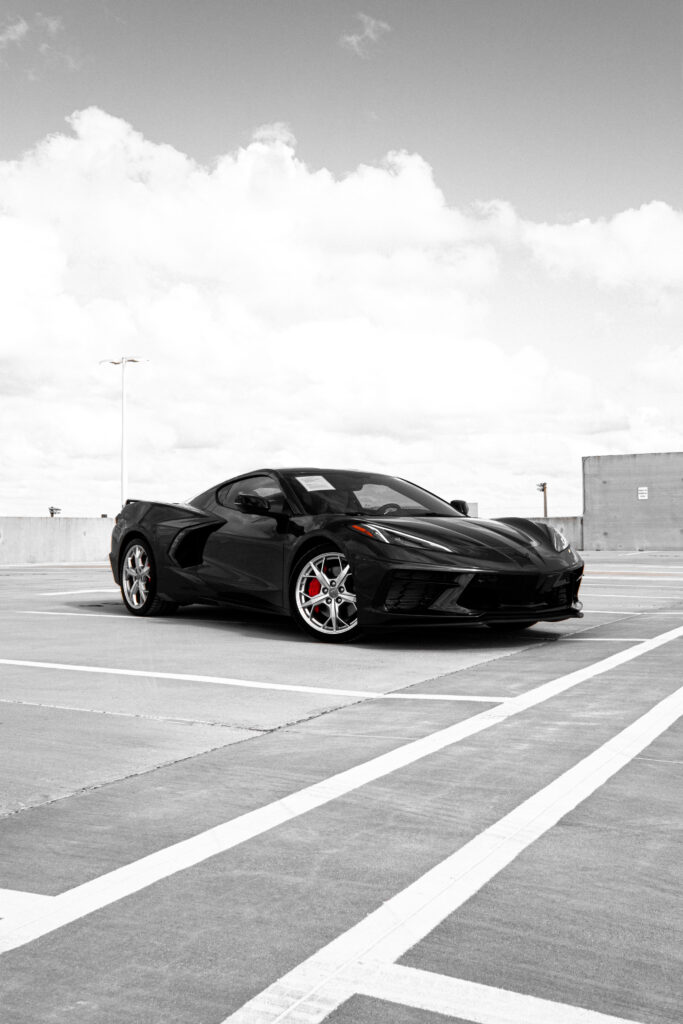 Sleek Black Sports Car Wallpaper: Aerodynamic Design & Dynamic Background