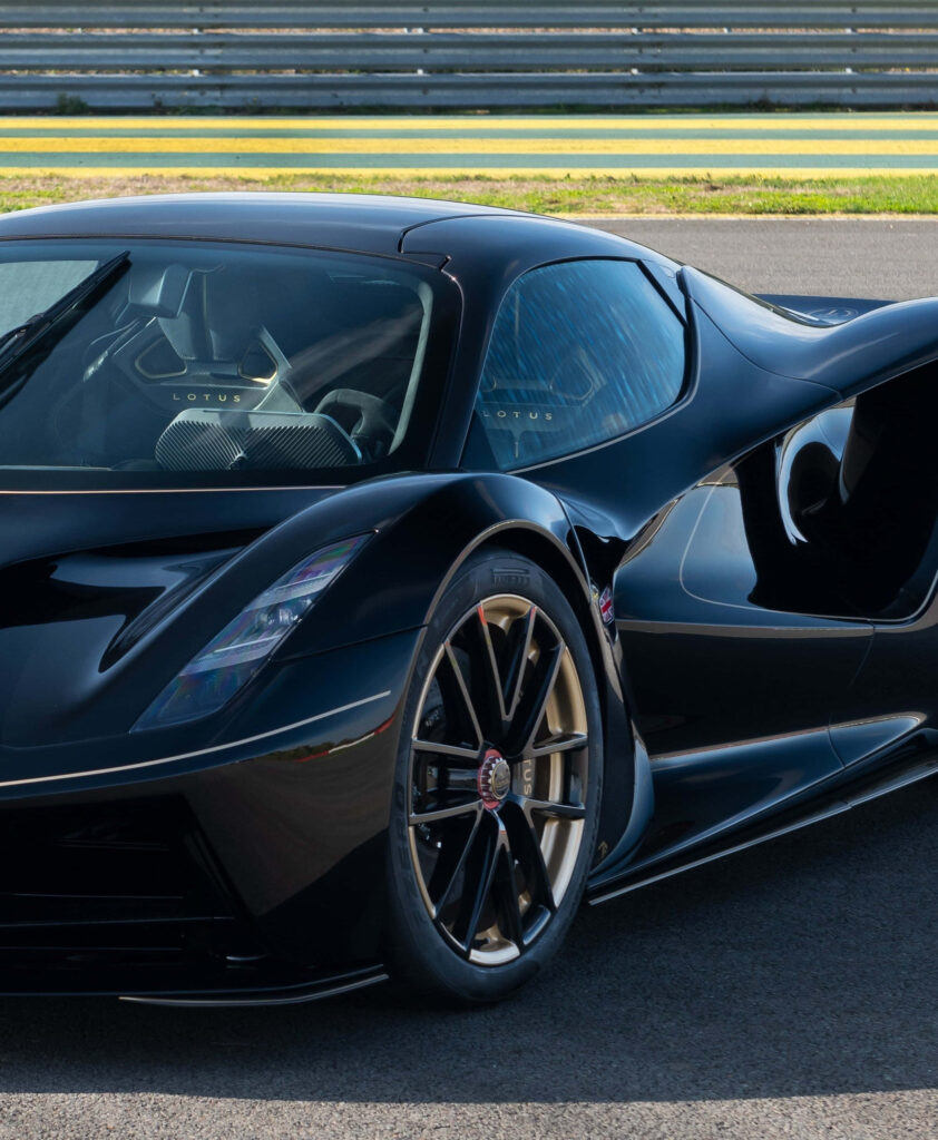 Black sleek sports car on racetrack symbolizing speed and ambition with wallpaper background