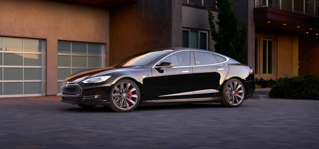 Sleek Black Tesla Model S in Urban Setting - Modern Elegance Wallpaper