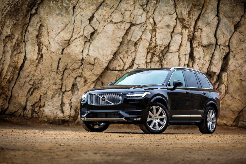 Sleek Black Volvo XC90 AWD Wallpaper with Rugged Rocky Background