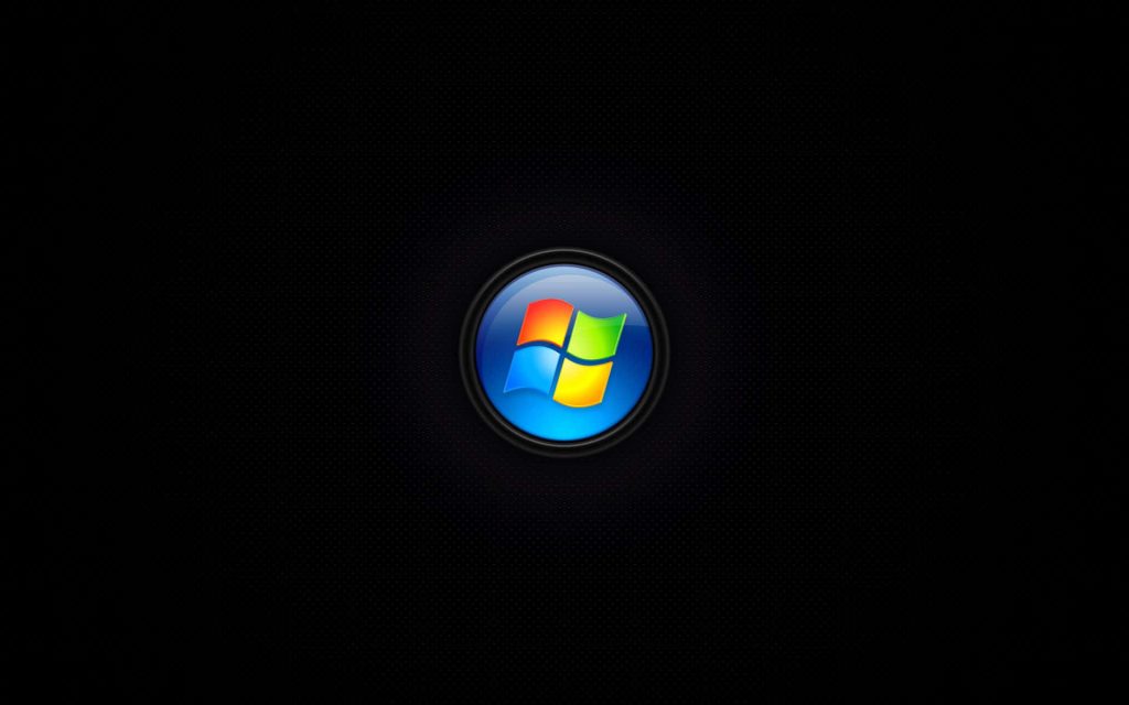 Sleek black Windows desktop background with colorful Microsoft logo in glossy glass orb center Wallpaper