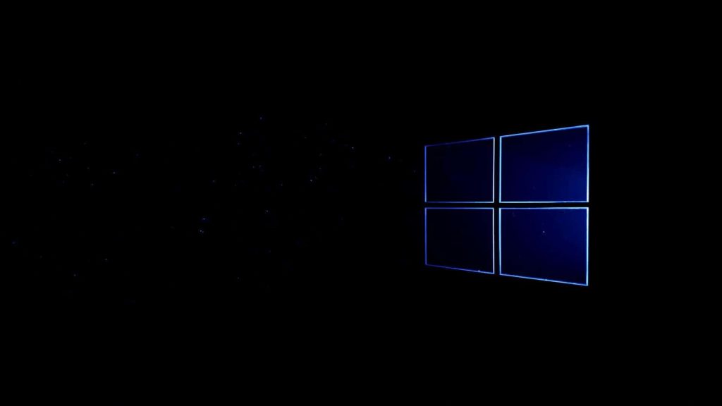 Sleek black Windows desktop wallpaper with glowing blue logo and subtle stardust background