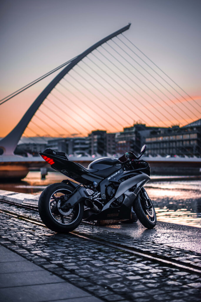 Serene Black Yamaha Motorcycle Wallpaper at Reflective Riverside Sunset