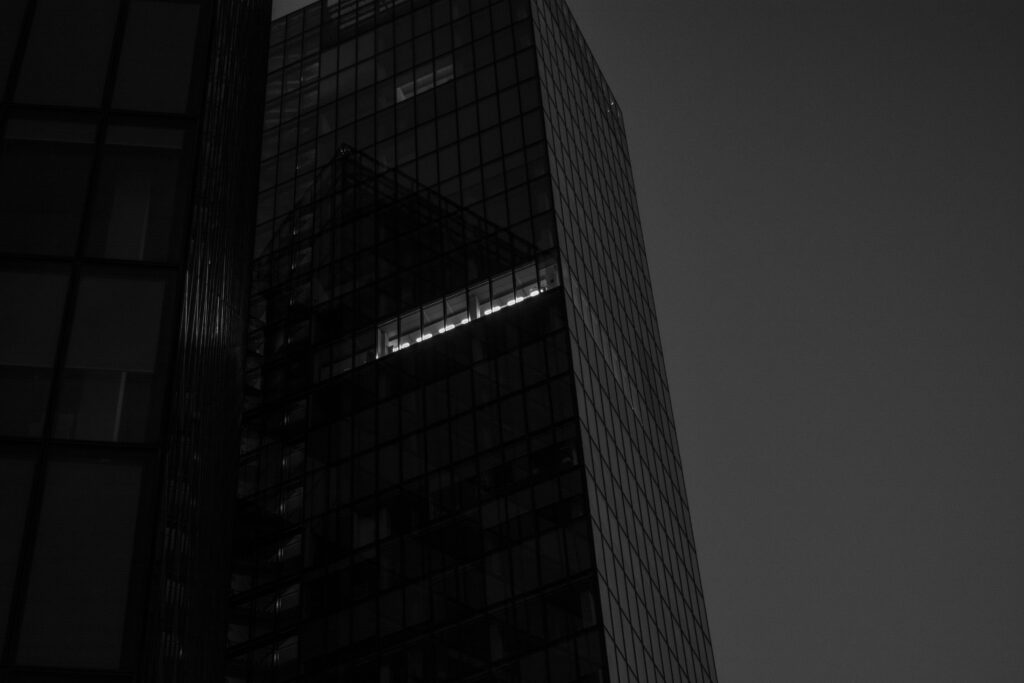 Sleek Black-and-White Skyscraper Wallpaper with Dramatic Lighting