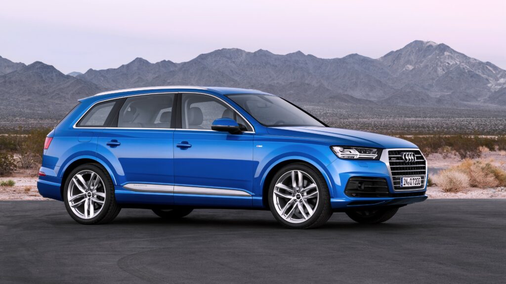 Stunning Blue Audi Quattro Wallpaper Against Rocky Mountain Background