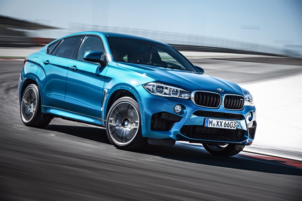 Sleek Blue BMW X6 in Motion on Racetrack - Dynamic Luxury Wallpaper