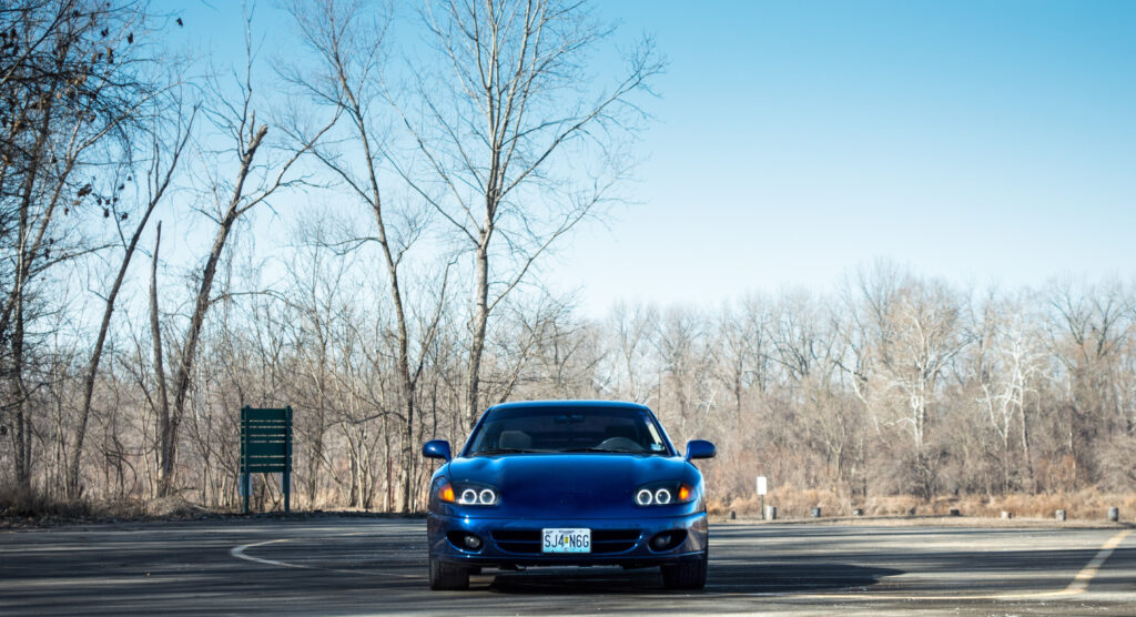 Blue Car Front View Wallpaper: Sleek Design in Winter Landscape