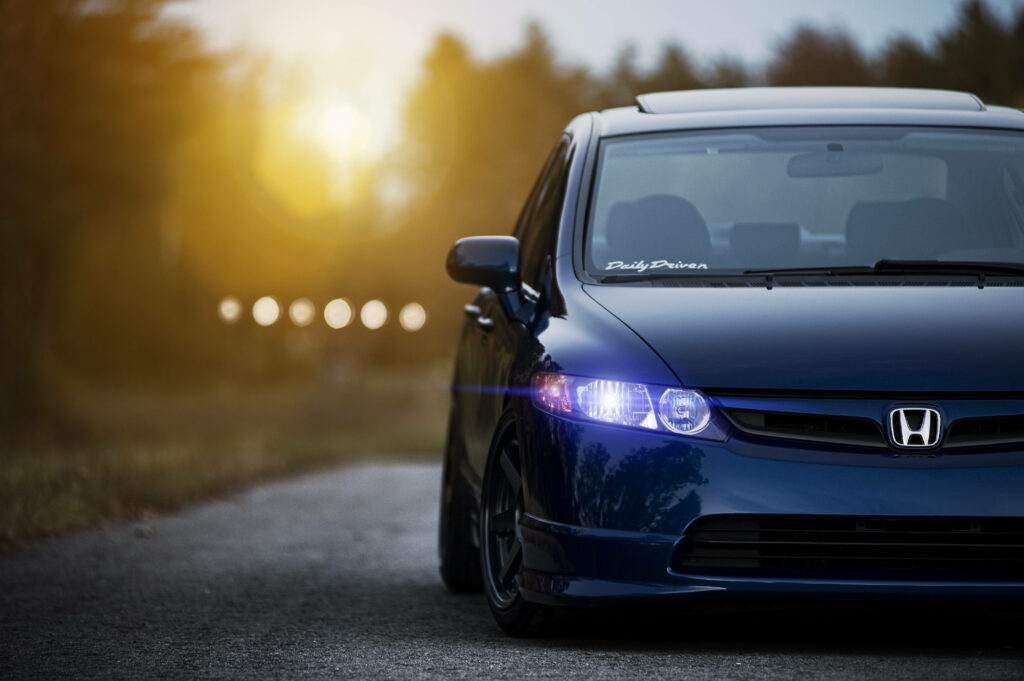 Blue Honda Civic parked on a quiet sunset road with glowing headlights and sleek modern design Wallpaper