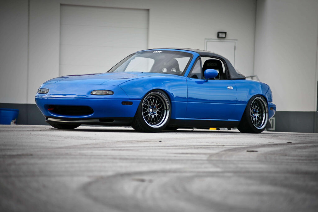 Vibrant Blue Mazda Miata Wallpaper: Sleek Automotive Background