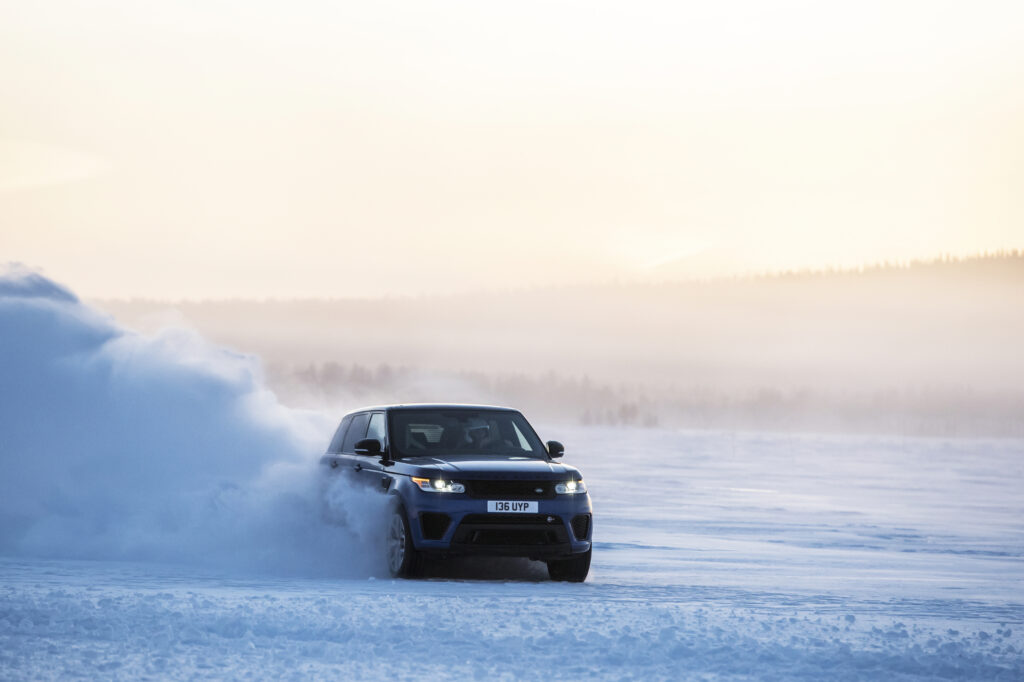 Sleek Blue Range Rover Sport in Motion: Winter Landscape Wallpaper