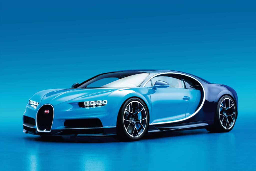 Blue sports car with sleek modern curves on vibrant blue background ready for the road Wallpaper