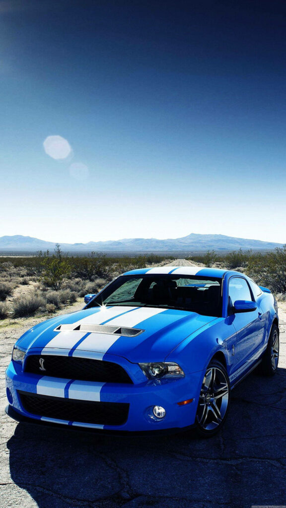 Stylish Blue Sports Car Wallpaper in Rugged Desert Landscape