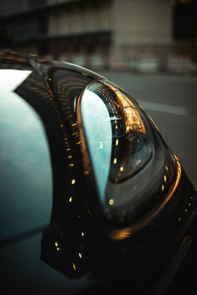 Sleek Car Headlight Close-Up: Artistic Reflections & Modern Elegance Wallpaper