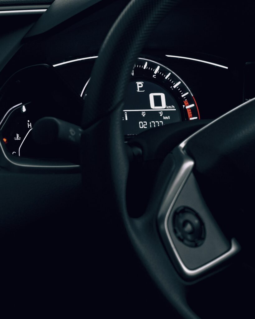 Sleek Car Interior Wallpaper: Speedometer & Steering Wheel Design