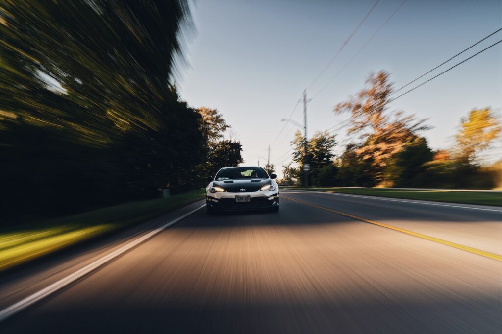 Sleek Car Racing: Dynamic Motion Blur Wallpaper for Adventure Lovers