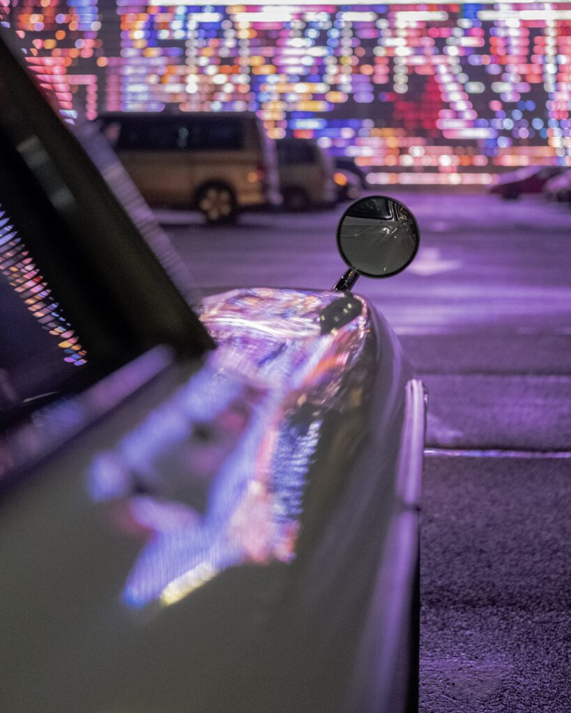 Futuristic Car Wallpaper: Sleek Vehicle with Neon Reflection
