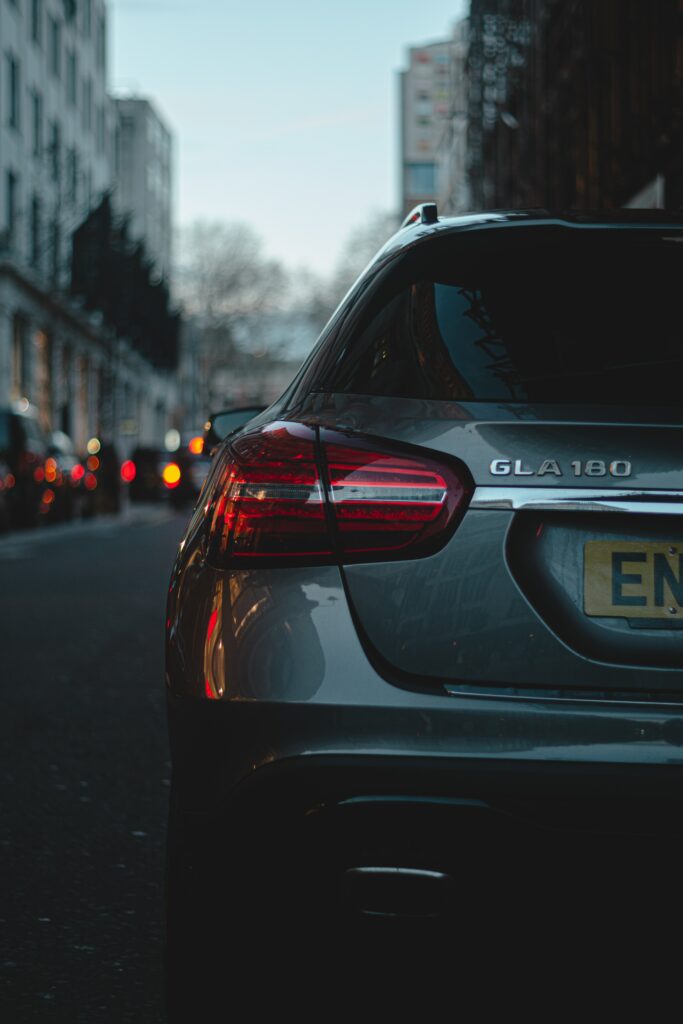 Stylish Rear View Car Wallpaper: Urban Evening Illumination