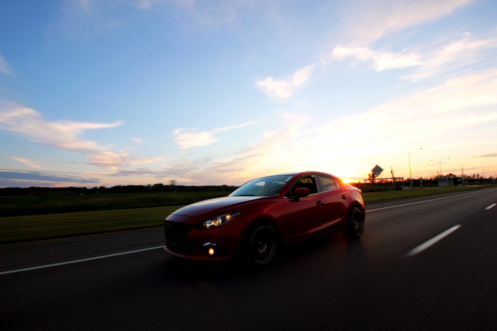 Sleek Car Silhouette at Sunset: Dynamic Highway Energy & Freedom Wallpaper
