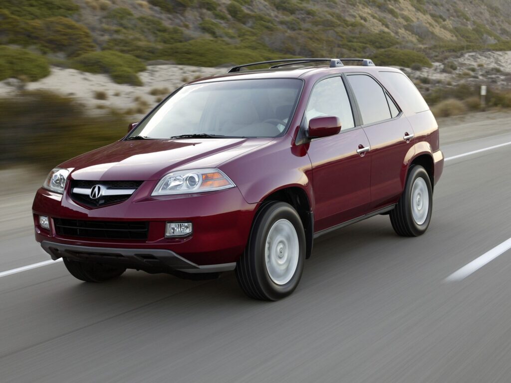 Dynamic Side View of Cherry Red Acura MDX on Scenic Track Wallpaper