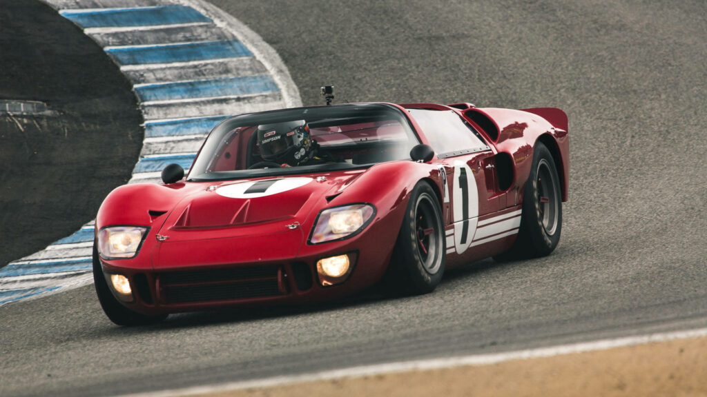 Sleek Cherry Red Ford GT Racing Wallpaper: Iconic Sports Car Action
