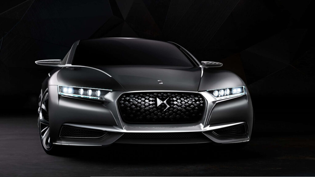 Sleek metallic gray DS Automobiles car with bold grille and futuristic LED headlights in low light Wallpaper