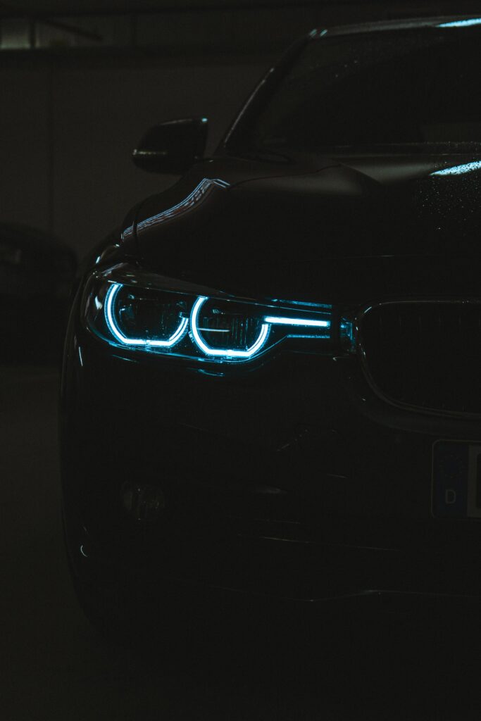 High-Resolution Dark Car Wallpaper with Striking Blue Headlights