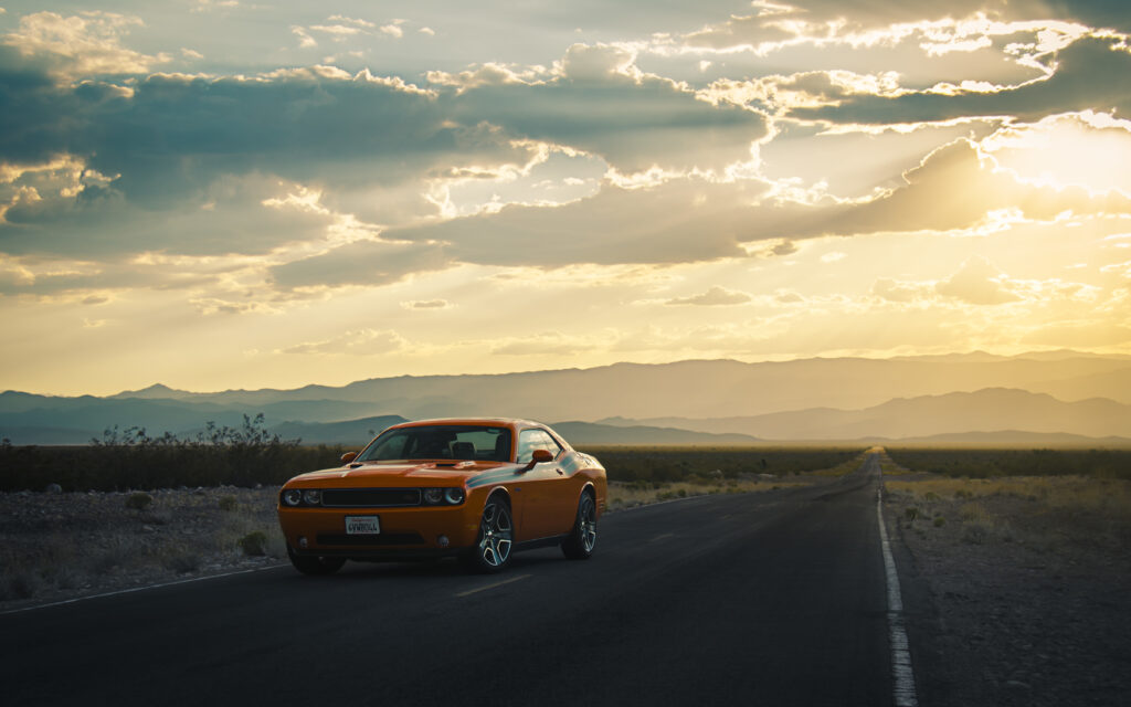 Dodge Challenger Side View Wallpaper: Adventure on an Open Road
